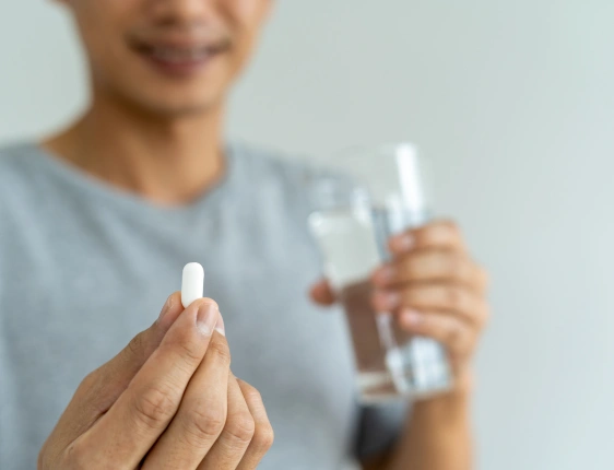 Adolescent medicine specialist consulting with a teenager and parent about growth, development, and preventive healthcare
