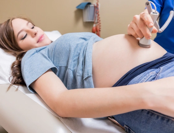 OB-GYN specialist performing a women's reproductive health examination and gynecological consultation