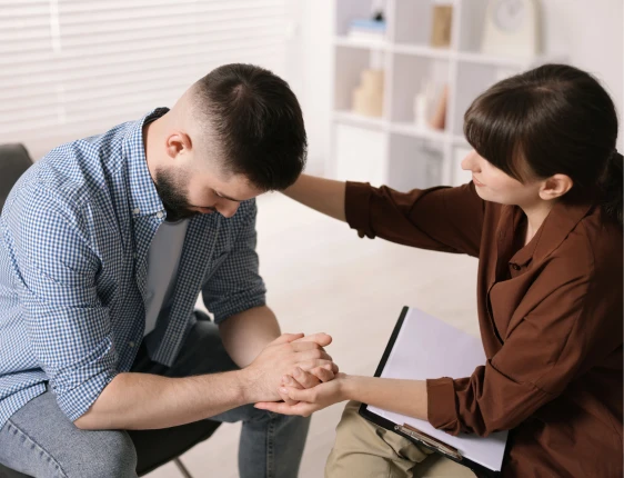 Psychiatrist discussing mental health symptoms and personalized treatment options with a patient during a behavioral health consultation.
